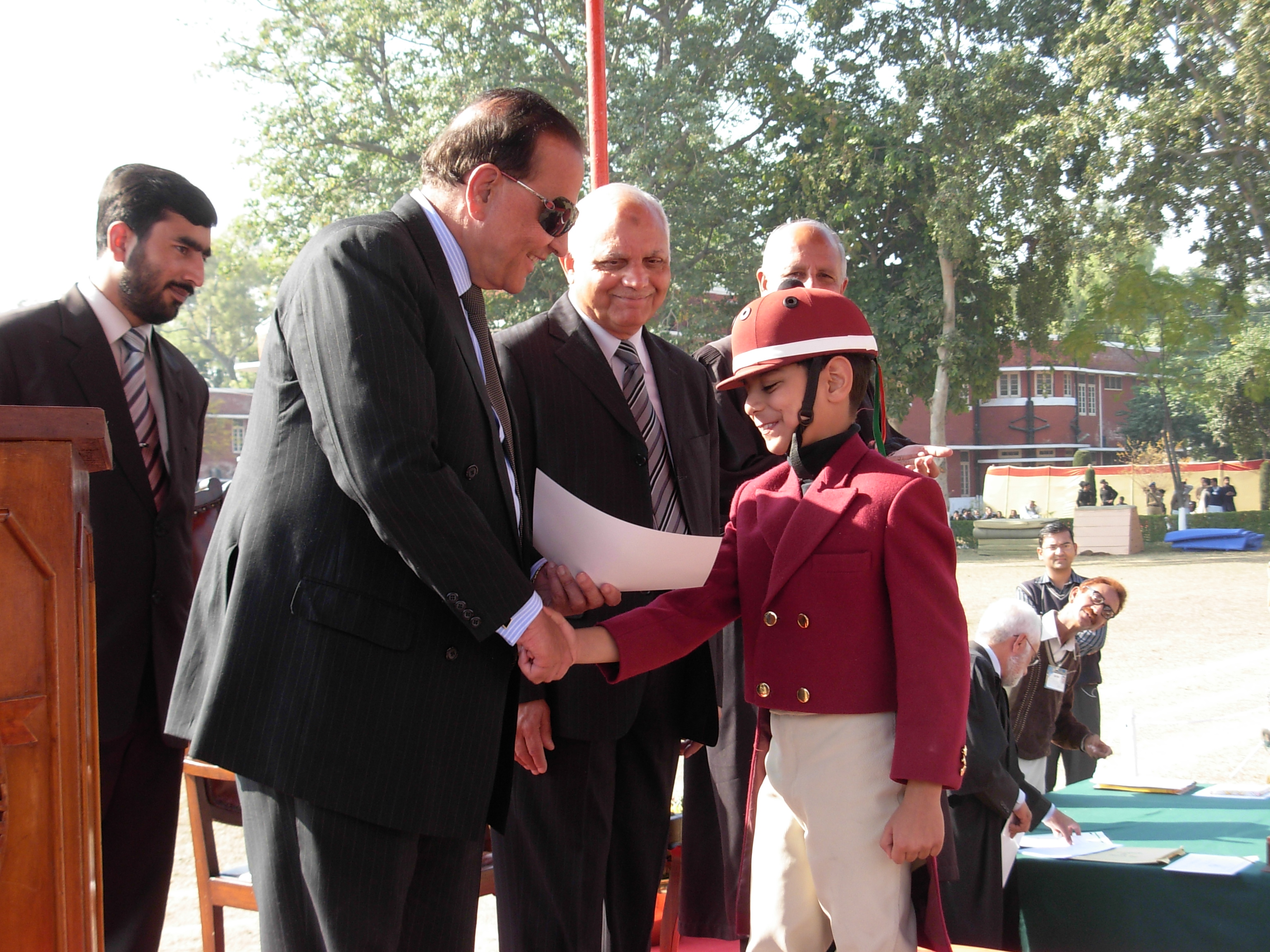 Ali receiving his award from the Governor